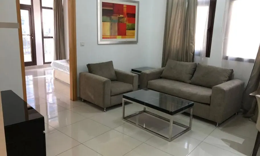 Immerse yourself in the elegance of modern living with this stunning 1BR apartment in Arjan, Dubailand. The living room is a harmonious blend of style and comfort, featuring a chic gray sofa and matching armchair paired beautifully with a sleek glass coffee table. Large windows adorned with curtains invite abundant natural light, enhancing the space. A vibrant abstract painting adds a splash of color to the pristine white walls, while the polished tiled floor guides you seamlessly to an open doorway leading to the tranquil bedroom.

Discover such exquisite spaces and more through Redlac Real Estate Dubai—your gateway to premier properties in one of the worlds most dynamic cities. Let us help you find your perfect home!.