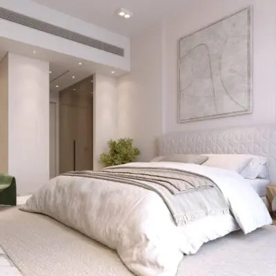 This modern bedroom epitomizes contemporary luxury living, featuring a spacious bed adorned with elegant white and beige bedding. An abstract painting serves as a striking centerpiece above the headboard, harmoniously paired with a sleek wooden side table. The room is tastefully enhanced by green armchairs in the corner, all bathed in soft natural light that underscores the apartments serene ambiance. Experience such exquisite living spaces with Redlac Real Estate in Dubai, where sophistication meets comfort.