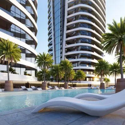 Experience modern luxury at its finest with Redlac Real Estate in Dubai. Imagine a serene pool area, perfectly complementing sleek contemporary living apartments. In the background, striking tall glass buildings curve elegantly against a backdrop of clear skies and warm sunlight. White lounge chairs invite relaxation by the waters edge, while tropical palm trees sway gently nearby. Discover this upscale oasis and more through Redlac’s exclusive properties in Dubai—where sophistication meets tranquility.