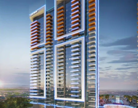 The image showcases Golf Gate 2, a sleek high-rise in Dubai with blue and orange lights set against a dusky sky. It features two towers offering luxurious apartments with breathtaking golf course views. Numerous balconies and a curved entryway enhance its appeal, surrounded by lush trees and pathways. Discover this gem through Redlac Real Estate, your key to elegant living in Dubai’s prime locations!.