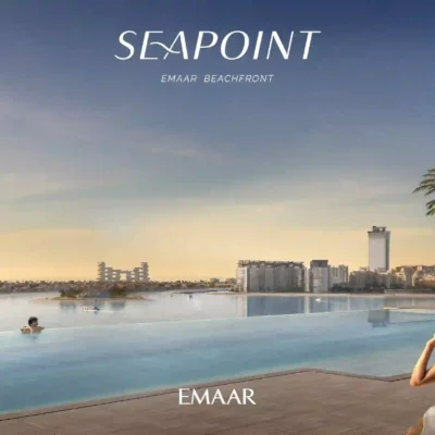 At Seapoint Residences, a tranquil beachfront scene comes to life with an infinity pool offering breathtaking ocean views. A sun-kissed individual wearing a sun hat lounges by the poolside, framed by the skyline of far-off buildings against a pristine sky. Discover such serene luxury and more with Redlac Real Estate in Dubai, where your dream property awaits at Emaar Beachfront.