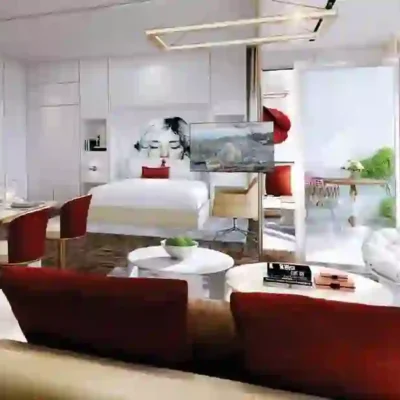 Experience the epitome of modern elegance in this chic hotel room, featuring a cozy double bed, vibrant red accents, and striking abstract wall art. Enjoy entertainment on a flat-screen TV or dine in style at the intimate seating area for two. Floor-to-ceiling windows reveal a stunning balcony view with lush greenery beyond. Discover such sophisticated living spaces with Redlac Real Estate in Dubai today!.