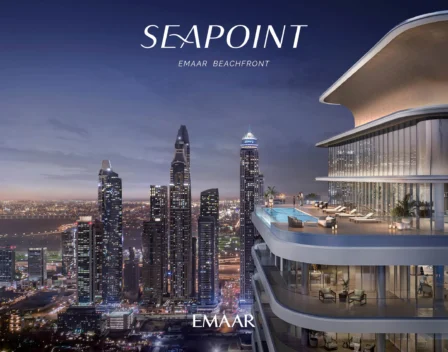 The image showcases a contemporary high-rise building with an opulent balcony that offers breathtaking views of the cityscape at dusk. The skyline is adorned with illuminated skyscrapers and a standout tower, while a QR code is subtly placed on the lower right corner. The elegant text Seapoint Residences Emaar Beachfront appears prominently above. For those seeking premium properties in Dubai, Redlac Real Estate offers an exceptional portfolio, providing you access to stunning residences like these to elevate your lifestyle in one of the worlds most vibrant cities.