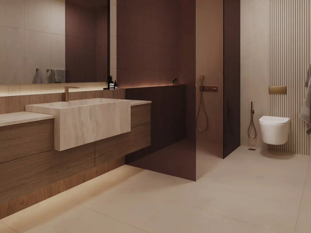 This sleek modern bathroom embodies minimalist elegance, showcasing a floating wooden vanity with a marble sink reminiscent of the luxury seen at Binghatti Ruby residences. A glass-enclosed shower and wall-mounted toilet add to its sophisticated charm, enhanced by soft lighting that highlights the earthy decor. Discover similar stunning designs with Redlac Real Estate in Dubai, where opulence meets functionality.