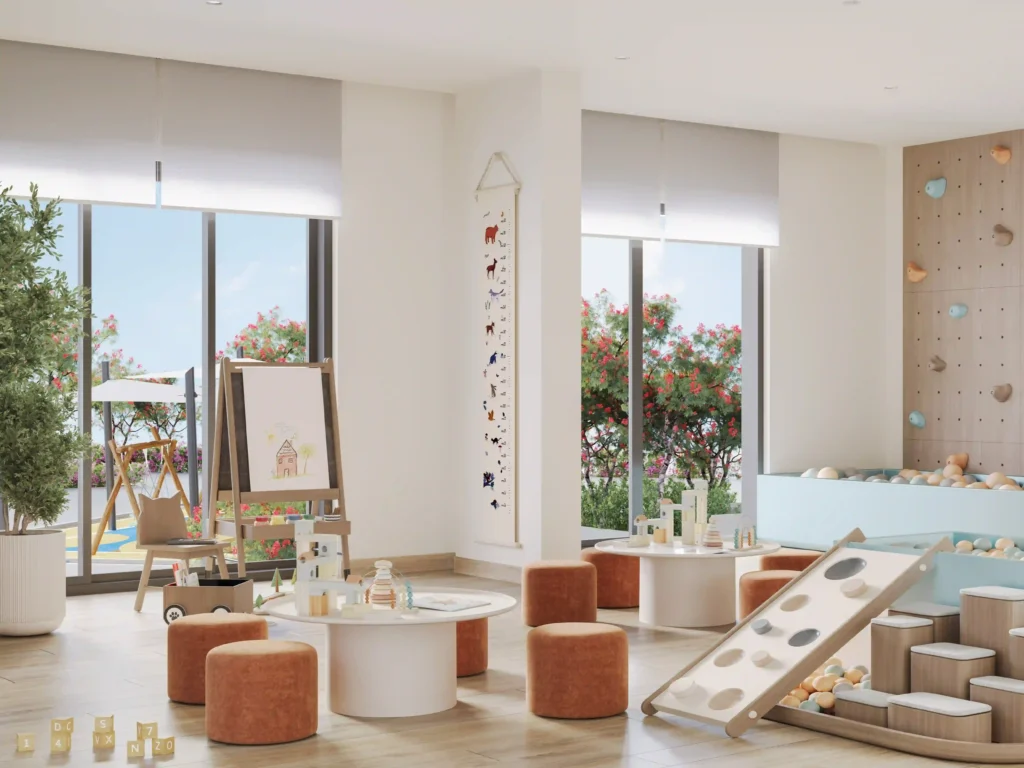 A vibrant childrens playroom boasts tables, orange stools, and a deluxe wooden climbing wall with a slide. Floor-to-ceiling windows frame an outdoor garden, while art supplies and toys are organized for cheerful charm and convenience. For such chic spaces in Dubais dynamic real estate market, consider Redlac Real Estate—experts in crafting family-friendly homes that blend style and function seamlessly.